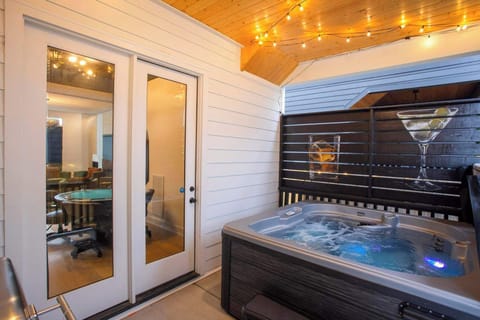 Level One: Outdoor patio with hot tub, grill, and picnic tables