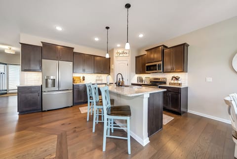 Your spacious kitchen awaits with granite countertops, stainless steel appliances, and a breakfast bar perfect for morning coffee or evening wine.