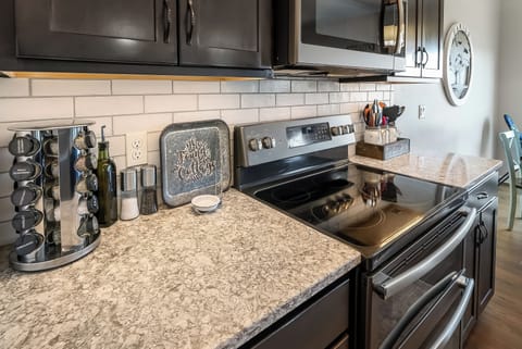 Your fully equipped kitchen awaits with granite countertops, stainless steel appliances, and thoughtful touches like a spice rack to inspire your culinary adventures.