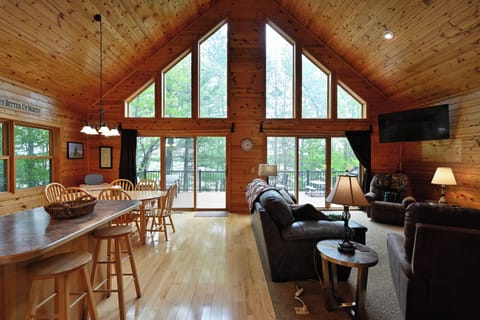 floor to ceiling windows overlooking the woods and lake