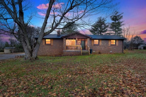 Front of home with solar pathway and Edison lights on covered porch.