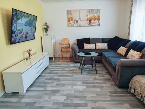 Spacious lounge with smart TV and corner sofa