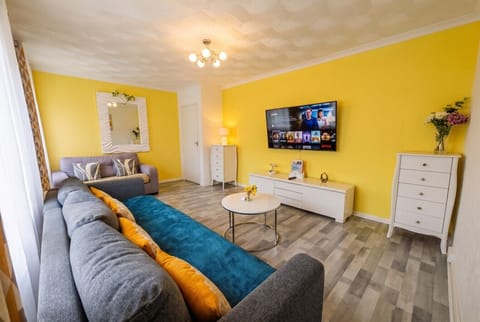 Sunny open lounge with big smart TV made for Netflix nights