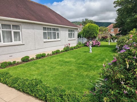 The guesthouse exterior framed by the surrounding garden.