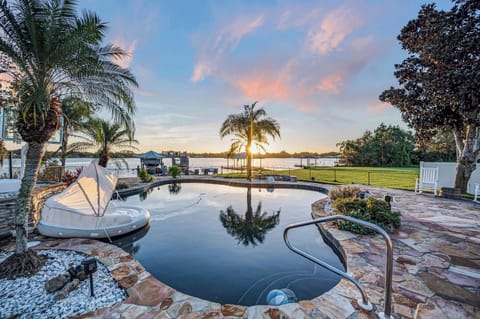Twilight magic where the serene lake meets the peaceful backyard—immerse yourself in the beauty of nature as day transitions to night.