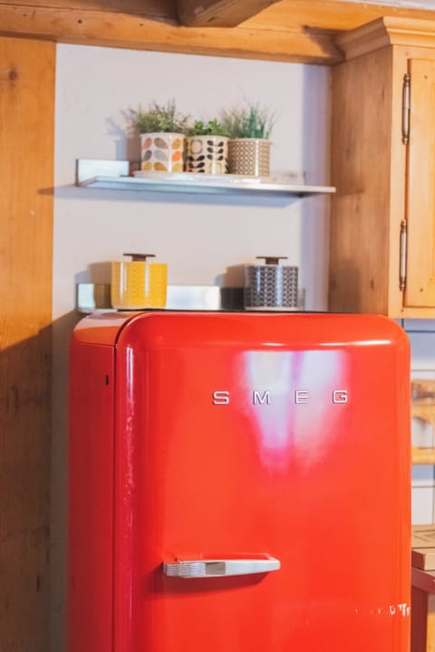 A second freestanding fridge freezer in the utility room provides ample storage
