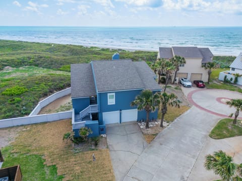 Charming beachfront property with stunning ocean views and tropical landscaping in a peaceful coastal neighborhood.