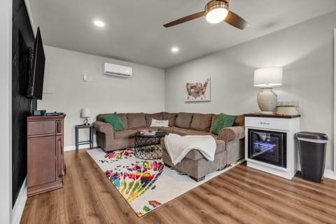 Livingroom with beverage cooler, large sectional and tv with 500+ Nintendo games