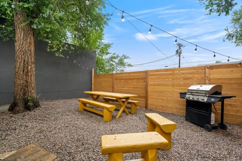 Enjoy your own fully fenced backyard with string lights, perfect for relaxing evenings or morning coffee.