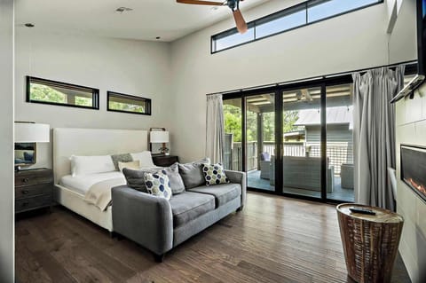 The inviting main living area features a king-size bed, a queen sofa bed large TV, and a cozy fireplace, ideal for unwinding after a day at the lake.