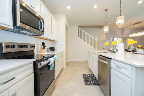 Prepare delicious meals in a contemporary kitchen with top-notch appliances, generous counter space, and a sleek, inviting design.