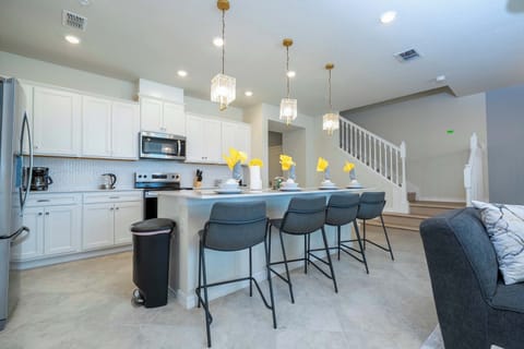 The open kitchen invites everyone to gather around the stylish island with seating for four-perfect for casual meals or enjoying morning coffee together.