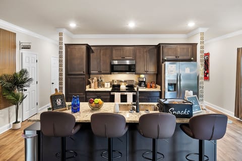 Kitchen island with seating for four and sleek bar stools for dining.