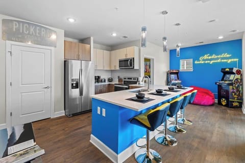 - Modern kitchen with bright blue island and bar seating 
- Stainless appliances and stocked cooking essentials 
- Ideal setup for long stays near local attractions 
