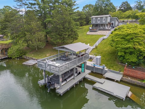 Spacious boathouse on Claytor Lake with upper deck seating, built-in bench, and easy water access.