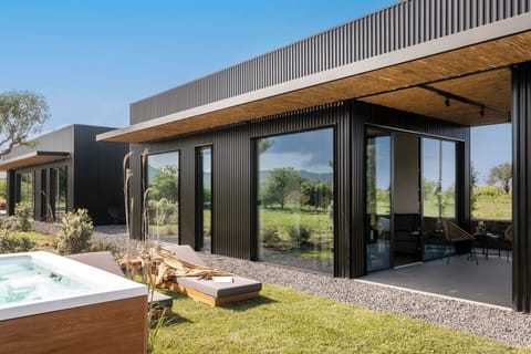 Deluxe bungalow with hot tub | Living area | 40-inch TV with digital channels