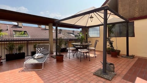a very large open-air space with small table, deck chair and pavilion, ideal to share moments in company