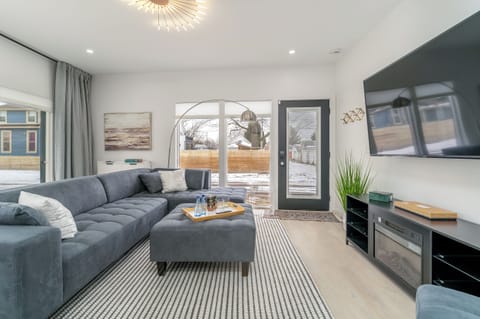 The room everyone ends up in. A deep sectional, big windows, and a slider to the patio keep six or seven people comfortably in one space after a long day downtown.