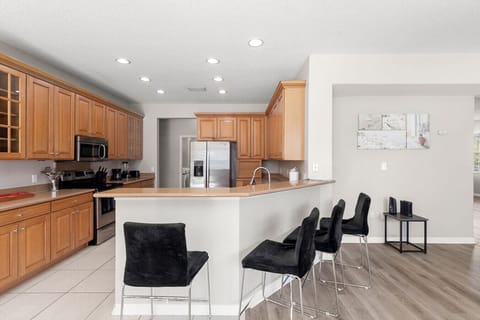 Kitchen | Modern design with stainless steel appliances, breakfast bar seating, and abundant cabinetry