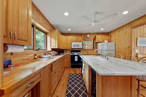 Spacious gourmet kitchen with ample counter space, modern appliances, and lake-view windows.