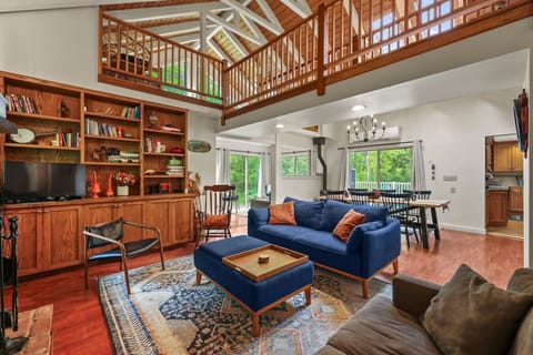 Comfortable lounge area with cozy seating, fireplace, and built-in shelving perfect for movie nights or reading.