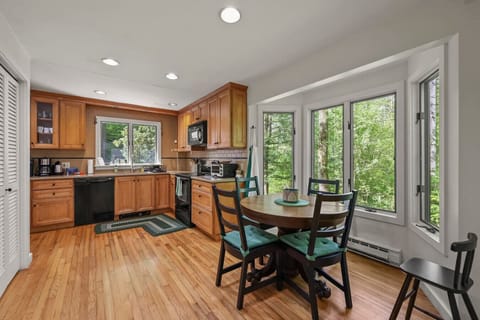 Cozy kitchen dining set for casual meals, coffee, or board games next to a large picture window.
