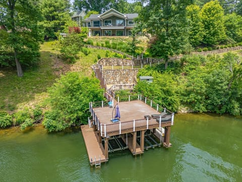 Spacious private dock on Claytor Lake with railings, umbrellas, and seating for 4—ideal for lakeside relaxation.