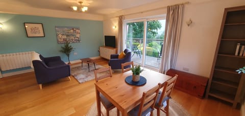 Living and dining area with sliding doors to deck and private garden.
