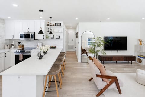 Open space living room featuring open kitchen and lost of natural sunlight
