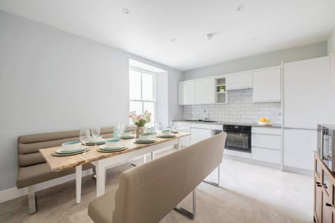 A sociable dining area featuring bench seating for family meals. Enjoy sharing food and conversations around the table in the open kitchen dining space, making hosting easy.