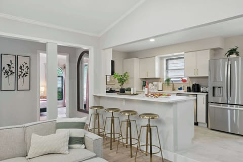 Fully stocked kitchen with sleek appliances and a bar area for casual bites or cocktails.