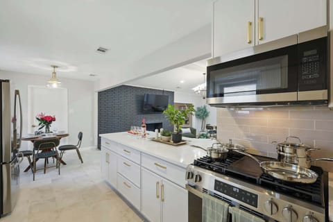 Grab a stool and enjoy a snack or drink at the breakfast bar. This sleek kitchen comes fully stocked and ready for anything.