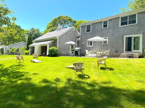 Spacious backyard with games, patio, grill, dining, seating...