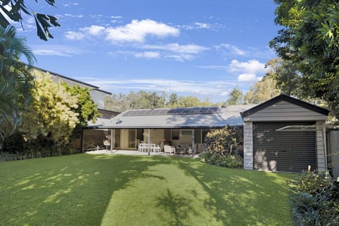 Fully fenced backyard with outdoor dining and seating area