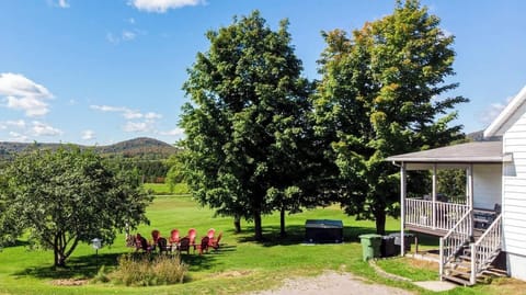 Adirondack chairs around the firepit, perfect for sunset views