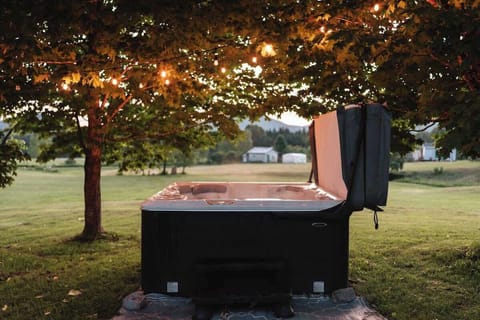 Relax in the hot tub surrounded by the serene beauty of nature