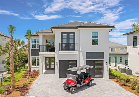 Sea La Vie - Private gated beach access steps away and FREE golf cart included! Private backyard oasis with heated pool, hot tub, sun loungers, and a covered porch with lounge seating.
