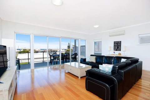Unwind in the light-filled, first living area with comfortable seating, air conditioning and seamless flow to the balcony, where ocean views and sea breezes set the tone for slow mornings and relaxed evenings.