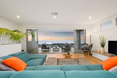 Relax in the light-filled living space where ocean views take centre stage, flowing seamlessly to the balcony for effortless indoor-outdoor living.