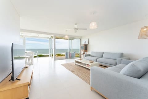 Unwind in the light-filled living space, where ocean views and sea breezes set the rhythm for slow coastal days.