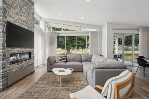Gather around the L-shaped sectional after a day at the beach, the glow of the fire setting the mood for relaxed conversation.