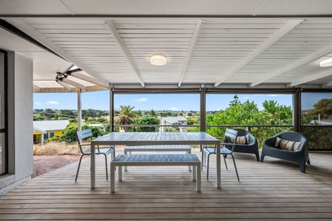 The private deck offers a breezy outdoor haven for long meals, relaxed conversations, and peaceful moments overlooking the treetops.
