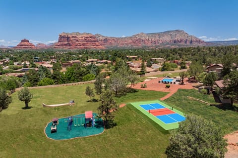[Resort Property] Backyard heated pool and spa with playground, and pickleball court.