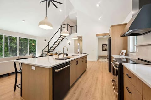 This high-end chef’s kitchen features GE Café appliances, All-Clad cookware, and a spacious island perfect for cooking together or catching up over wine.