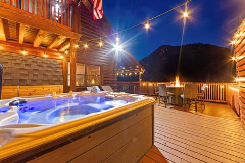 Hot tub with mountain views and firelight—your night, your magic unwind
