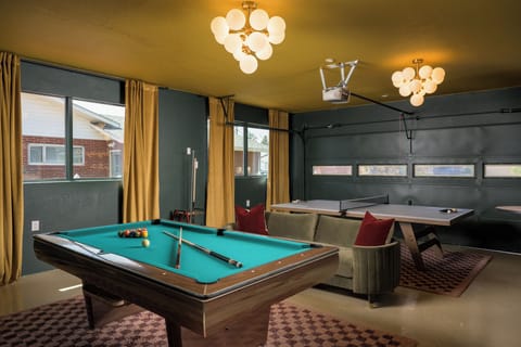A vibrant entertainment zone with pool, ping pong, and lounge seating for endless fun with friends.