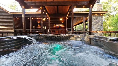 Bubbling hot tub on the covered back deck with outdoor TV and string lights - rainy night? Still the best seat in the house.