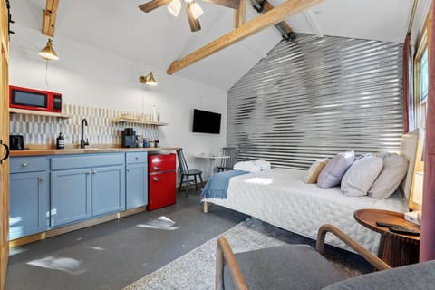 Stylish loft space with cozy bed and kitchenette.