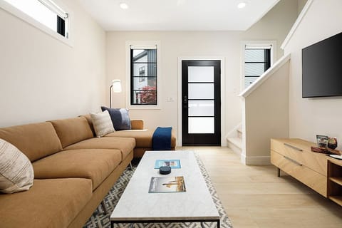 Bright and inviting living space with a smart TV, ideal for movie nights or lazy afternoons.