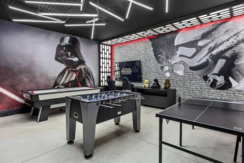 Experience a vibrant game room adorned with bold black and white murals that add adventure to your stay. Enjoy hours of fun at the sleek foosball and ping pong tables, all under modern lighting that enhances the lively ambiance.